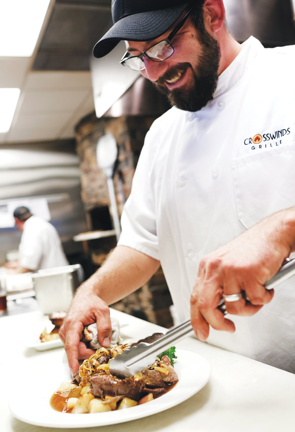 Chef Nate Fagnilli plating beef shank