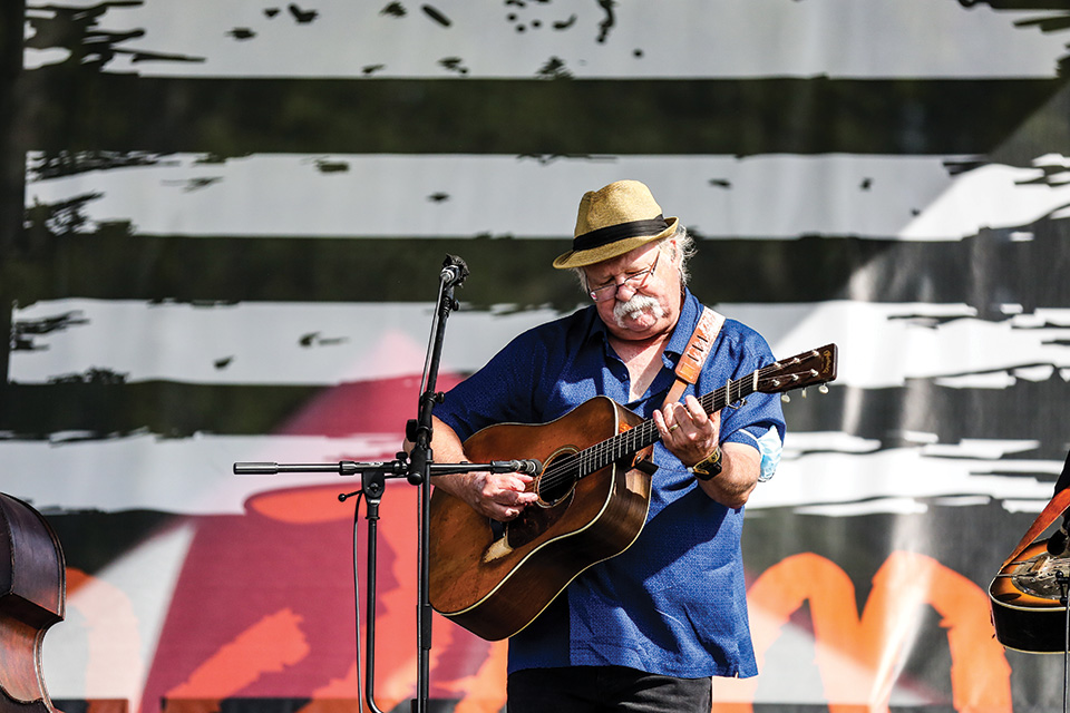 Man playing guitar at SamJam Bluegrass Festival (photo by Jennifer Buckler)