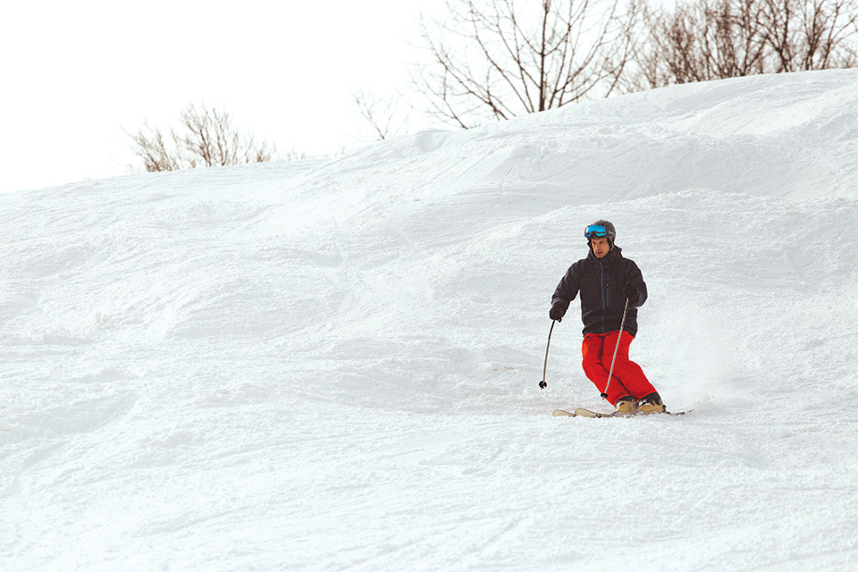 Man skiing at Boston Mills/Brandywine Ski Resort Man skiing at Boston Mills/Brandywine Ski Resort