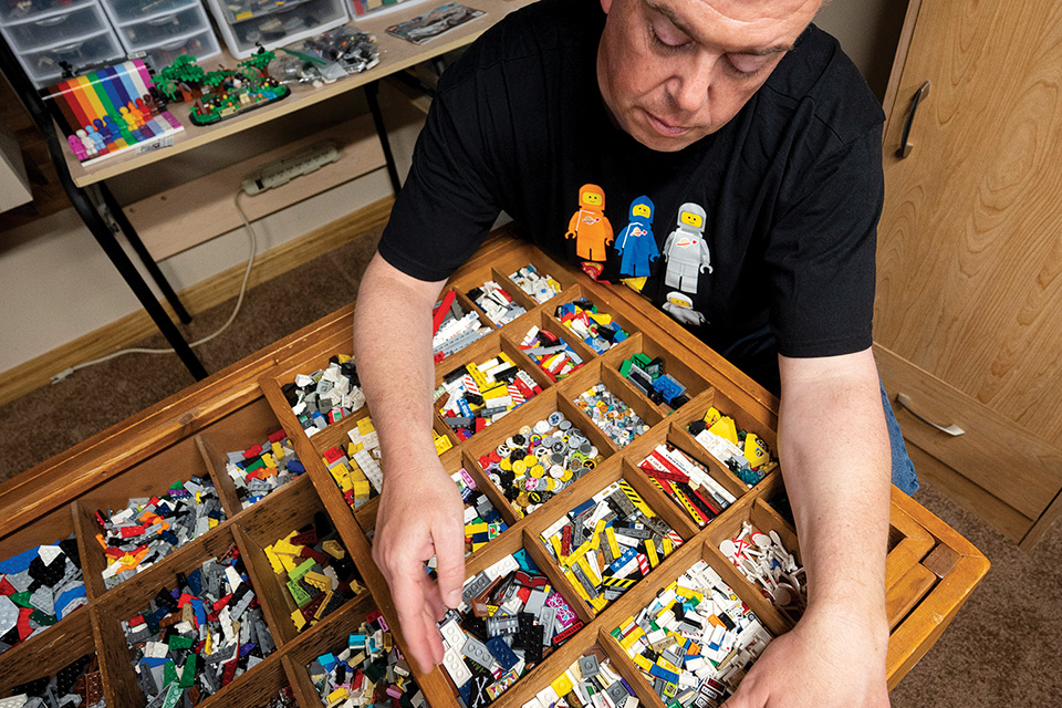 Scott Brown sifting through various Lego pieces (photo by Ken Blaze)
