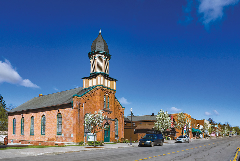 A church and shops in Mayville, New York (photo by Laura Watilo Blake)