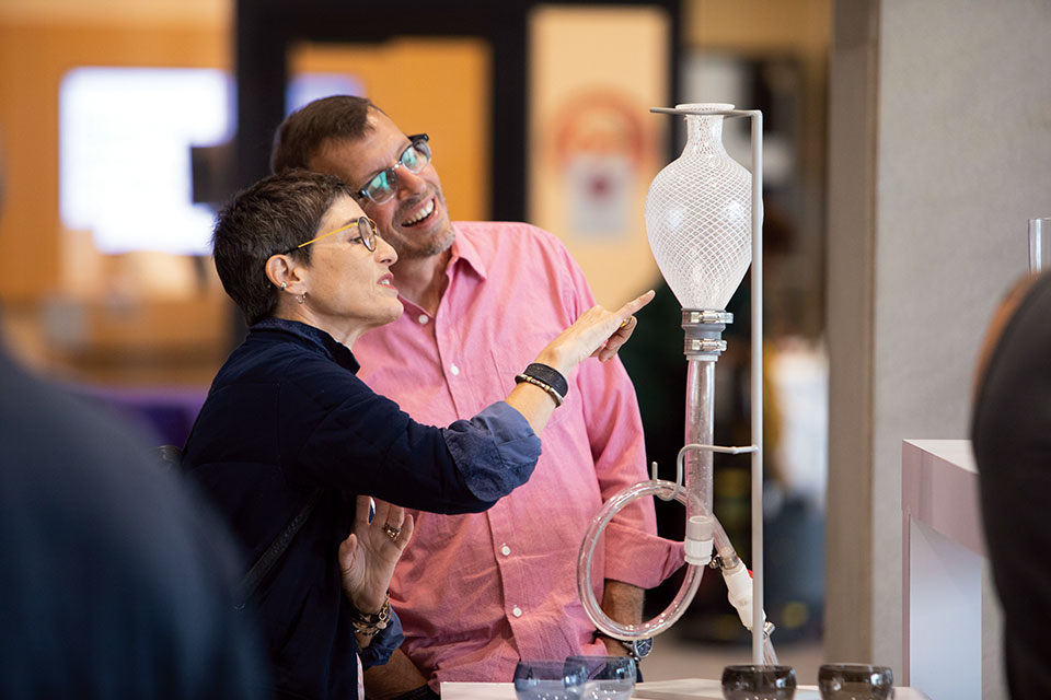 People looking at glass art at Momentum Festival in Toledo (photo by Schooler Studios)