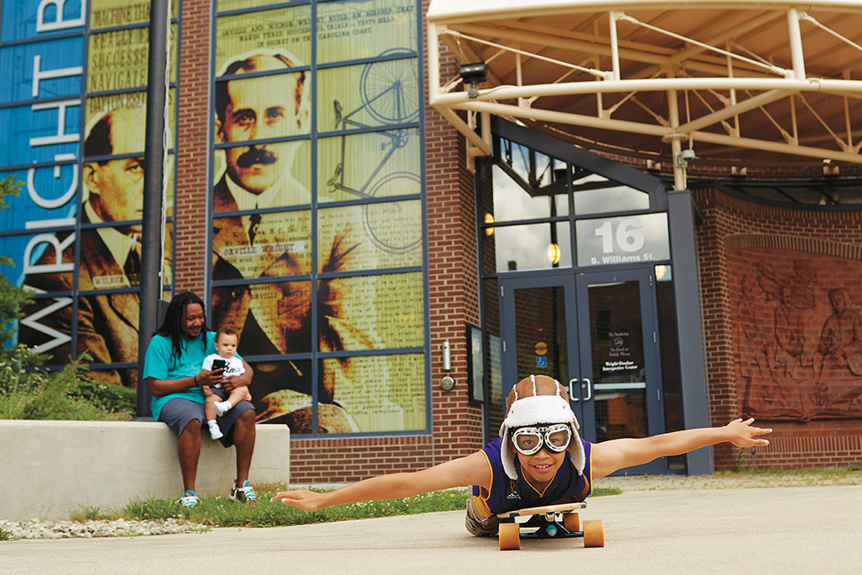 Dad and children in front of Wright-Dunbar Interpretive Center & Aviation Trail Visitor Center (photo by Casey Rearick)