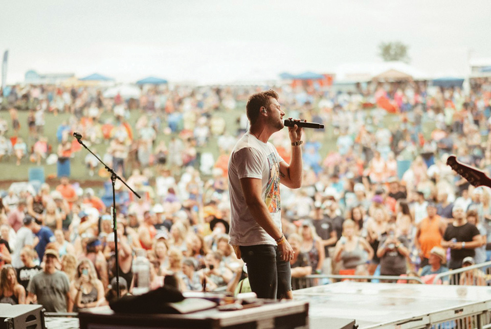 Man singing on stage at Blame My Roots Festival (photo courtesy of Blame My Roots Festival)