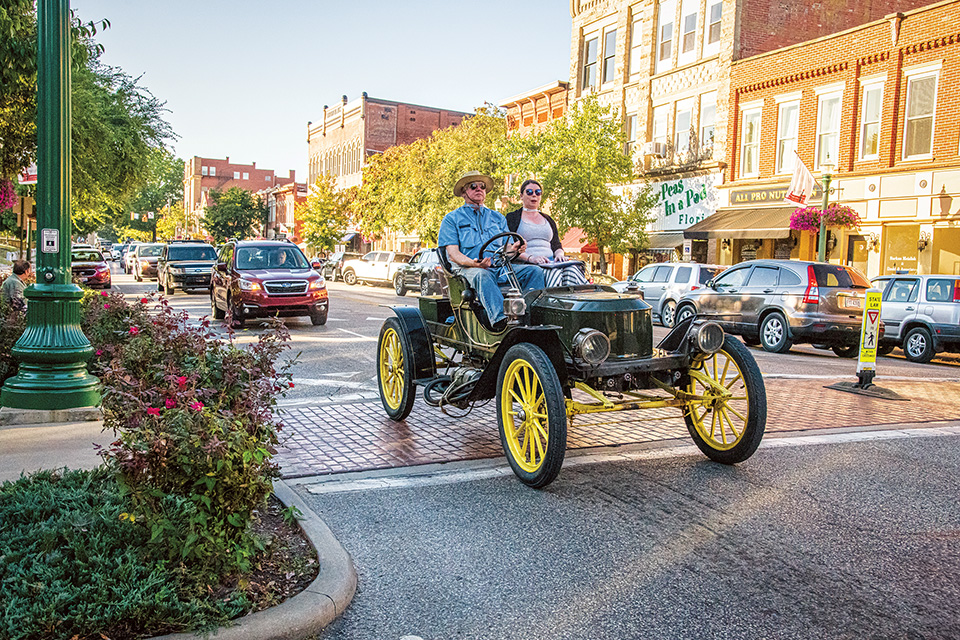 People in vintage car driving in downtown Marietta (photo courtesy of Marietta-Washington County Convention & Visitors Bureau)