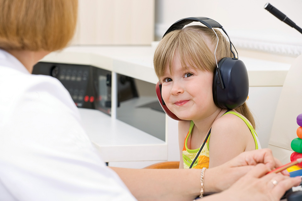 Child taking hearing test (photo by iStock)
