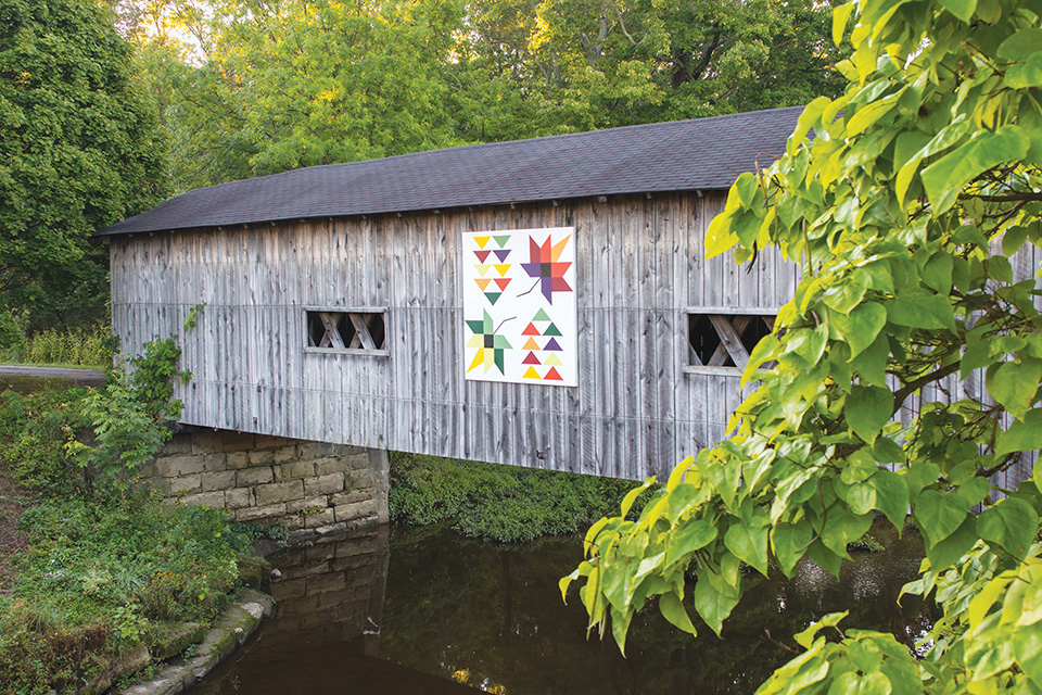 Ashtabula County “Flying Geese and Leaves” quilt pattern on covered bridge (photo by Carl Feather)