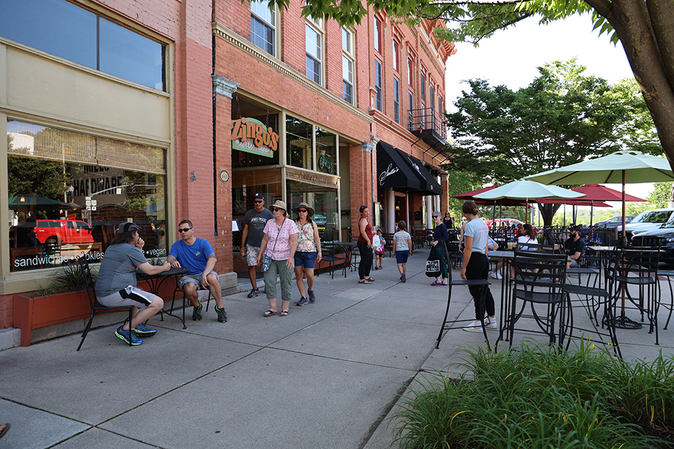 People walking and talking in downtown Perrysburg by Zingo’s Mediterranean restaurant (photo by Rachael Jirousek)