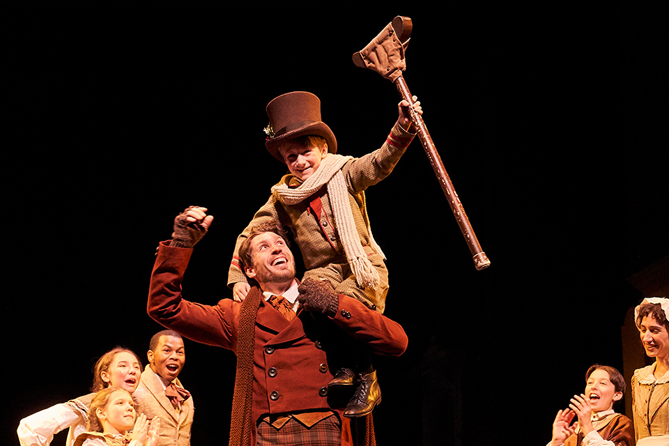 Tiny Tim on Bob Cratchit’s shoulders in “A Christmas Carol” at Great Lakes Theater in Cleveland (photo courtesy of Great Lakes Theater)