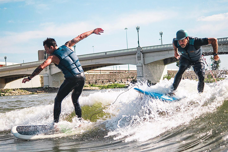 Two men surfing on the Great Miami River with Surf Dayton (photo courtesy of Surf Dayton)