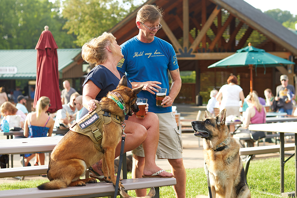 Couple with dogs drinking beer at Debonne Vineyards (photo courtesy of Debonne Vineyards)