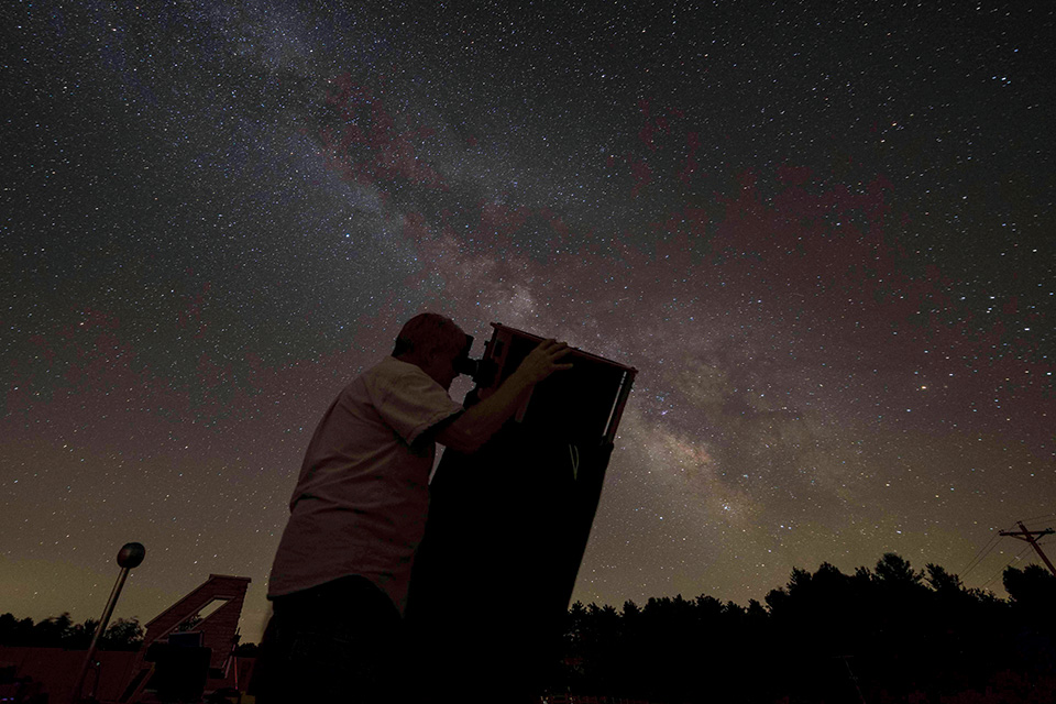 Man stargazing at John Glenn Astronomy Park in Logan (photo by Brad Hoehne)