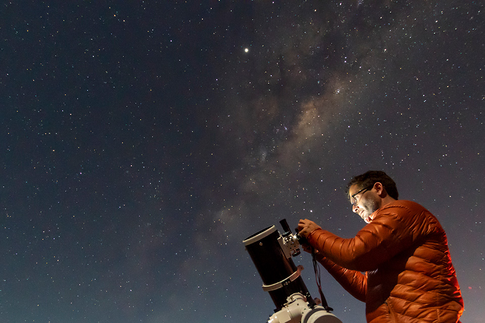 Man operating stargazing gear (photo by iStock)