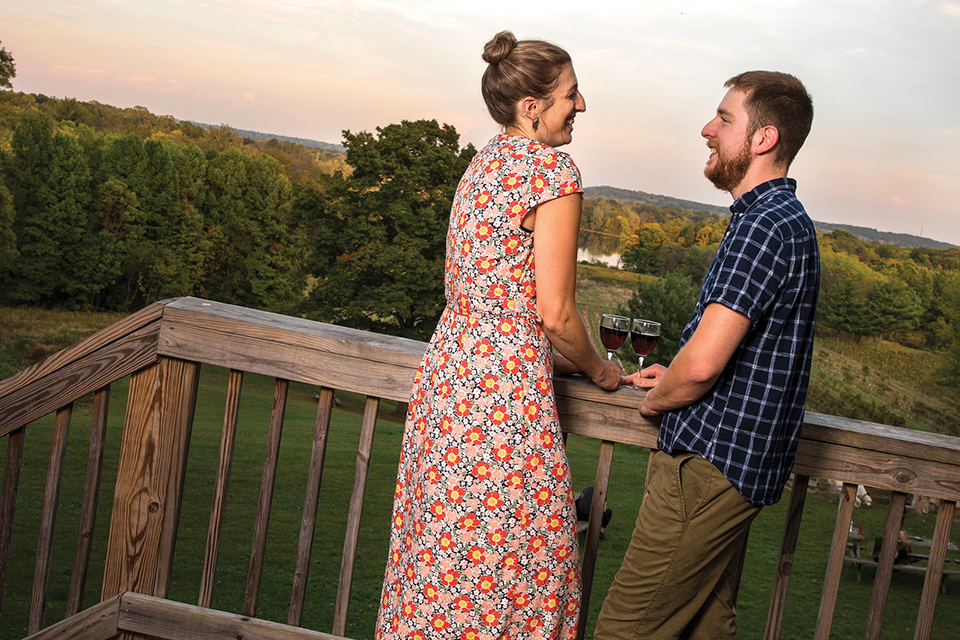 Couple drinking wine on patio at Winery at Wolf Creek in Norton (photo by Karin McKenna)