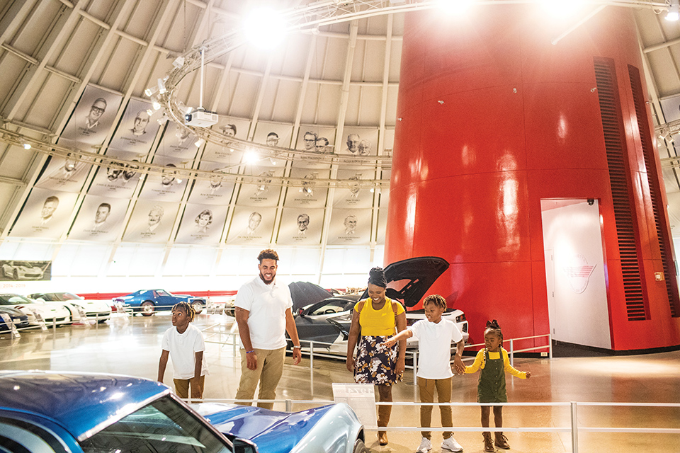 Family looking at car at the National Corvette Museum in Bowling Green, Kentucky (photo courtesy of National Corvette Museum)