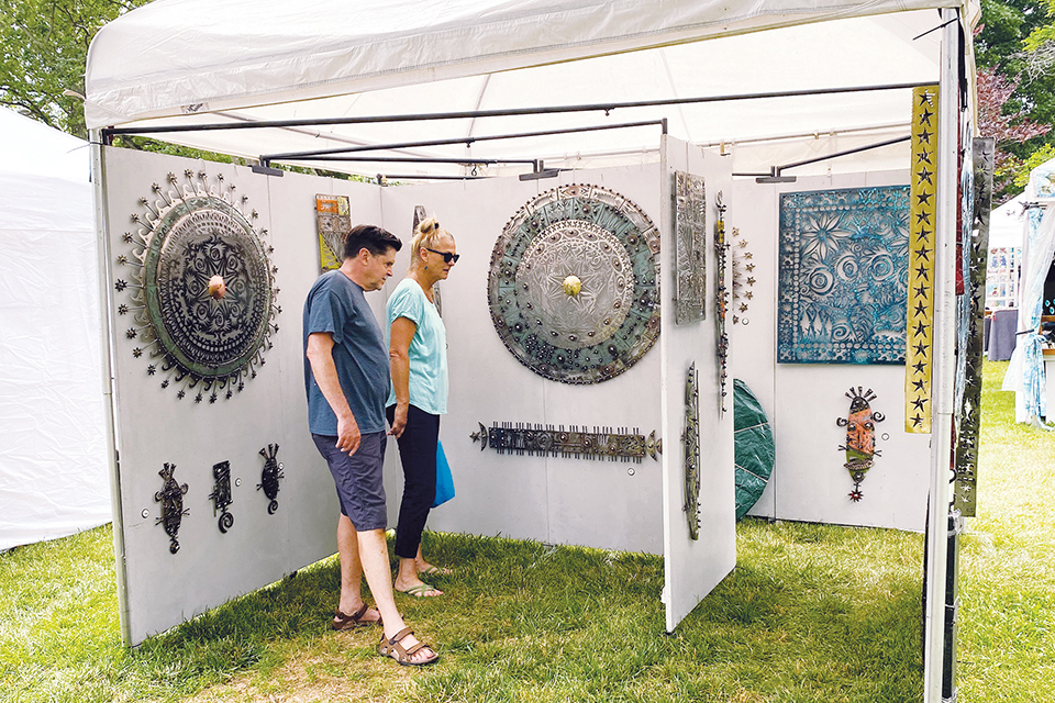 Man and woman browsing works at Toledo’s Crosby Festival of the Arts (photo courtesy of Toledo Grows)