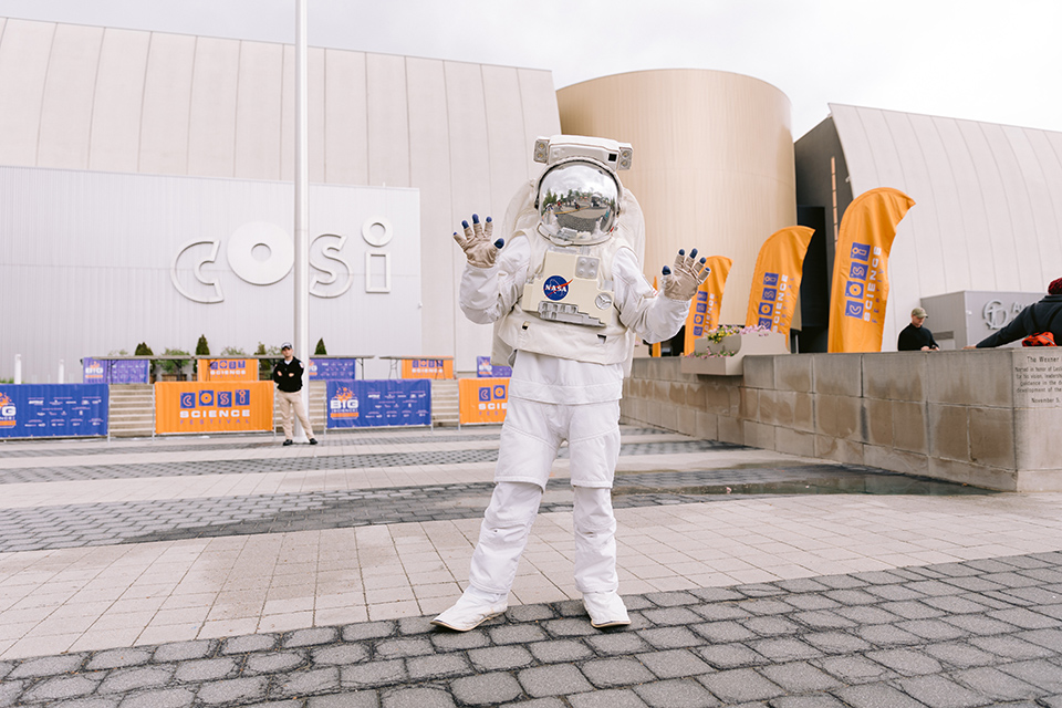 Person dressed as astronaut standing outside COSI in Columbus (photo by Alli Mullikin for Robb McCormick Photography)
