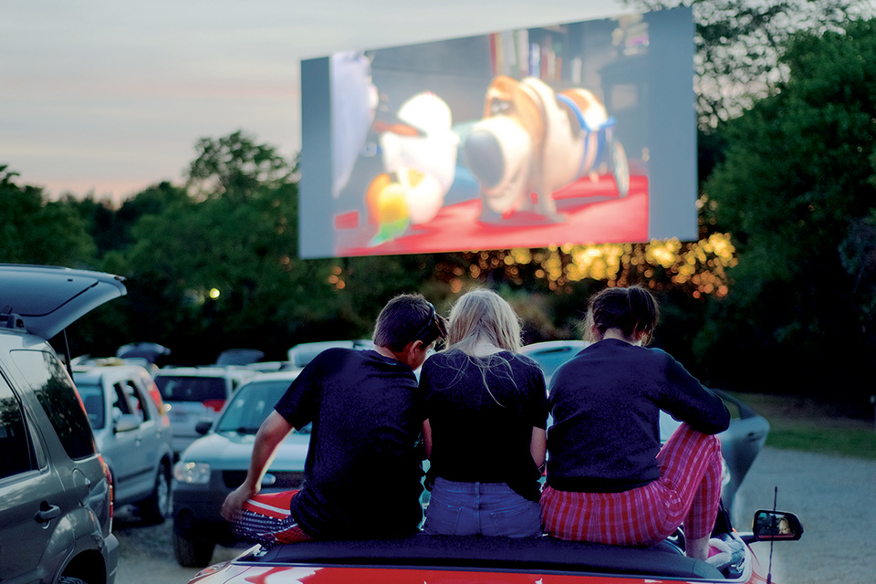 Kids sitting on car watching movie at Holiday Auto Theatre in Hamilton (photo courtesy of Travel Butler County)