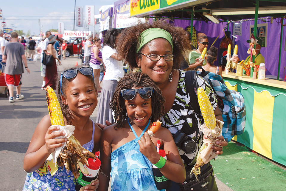 Mom and daughters enjoying midway foods at the Ohio State Fair in Columbus (photo courtesy of Ohio State Fair)