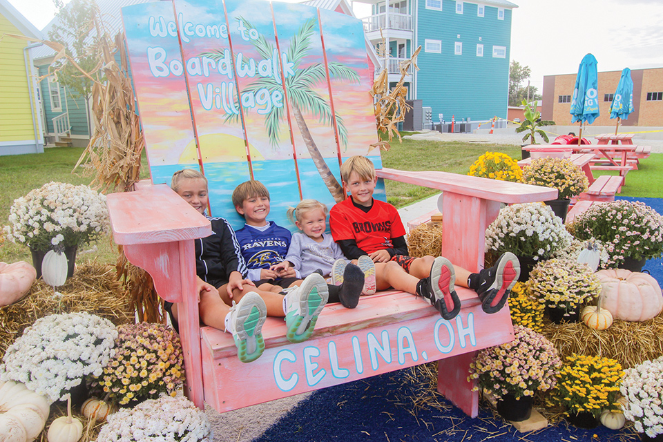 Four kids on big beach chair at Celina’s Boardwalk Village (photo courtesy of Boardwalk Village)
