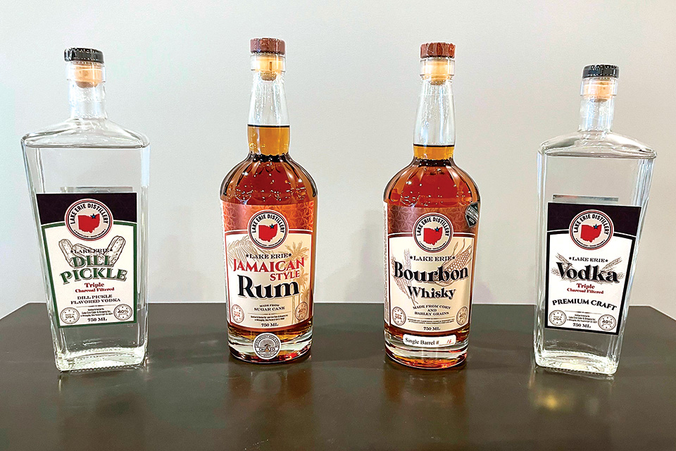 Bottles of dill-pickle-flavored vodka, Jamaican-style rum, bourbon and triple-charcoal-filtered vodka (photo courtesy of Lake Erie Distillery)