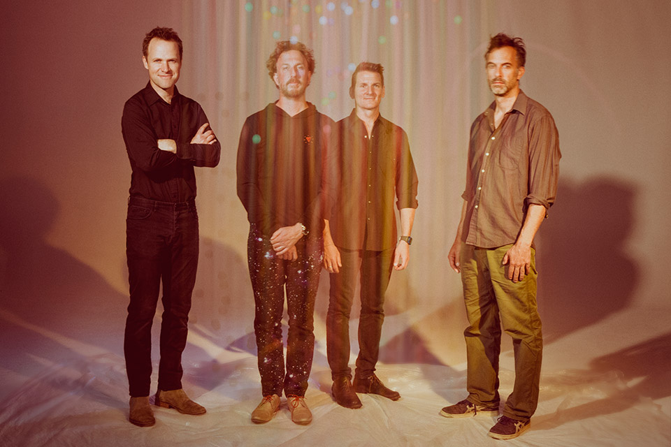 Band members of Guster standing together (photo courtesy of Alysse Gafkjen)
