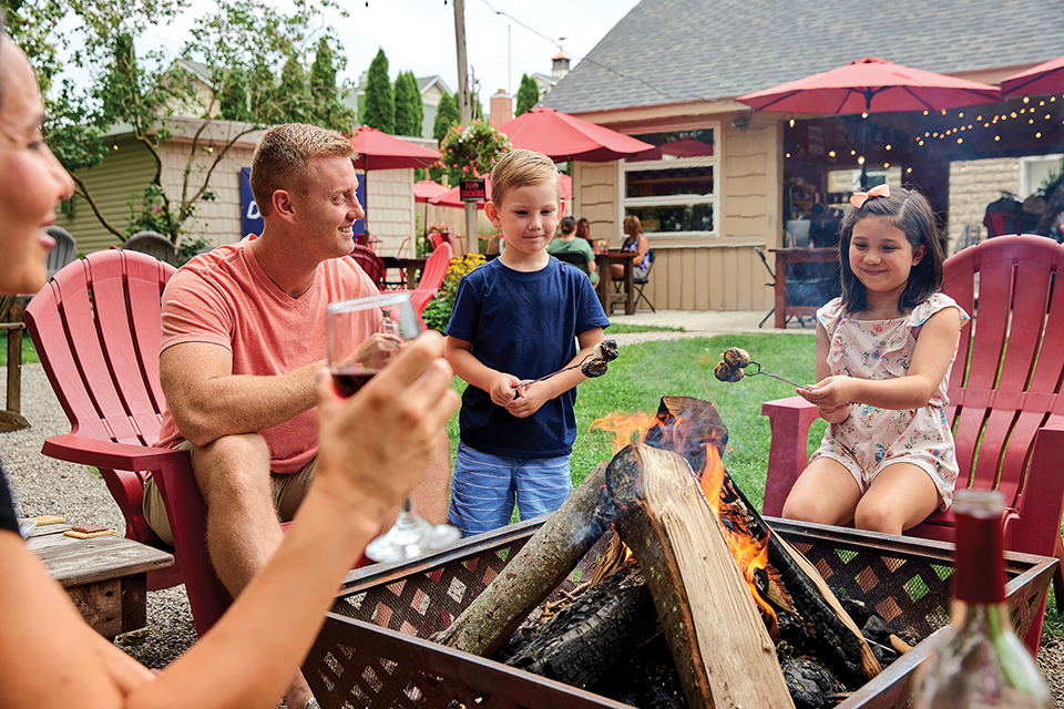 Family roasting marshmallows around a fire at Red Fern Inn and Rocky Point Winery in Marblehead (photo courtesy of Red Fern Inn and Rocky Point Winery)