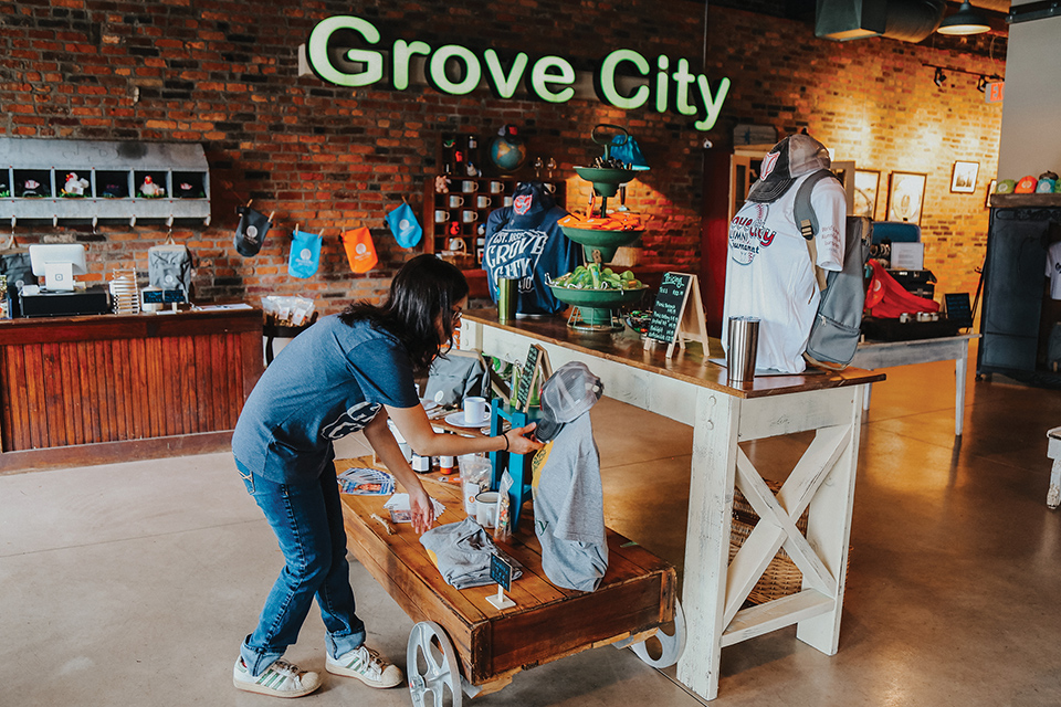 Girl looking at local goods in Grove City Guide + Gear (photo courtesy of Visit Grove City)