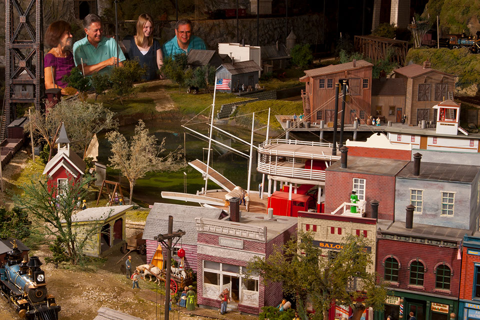 People watching trains at one of the immersive displays at Entertrainment Juntion (photo courtesy of Entertrainment Junction)