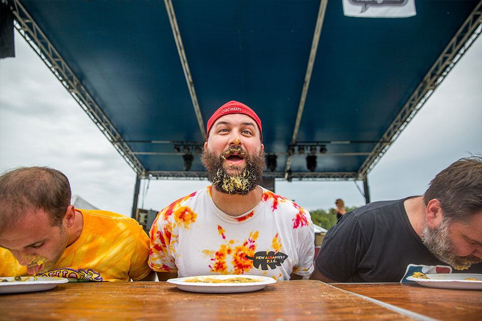 Man taking part in the pawpaw-eating contest (photo by Joel Prince, courtesy of Athens County Convention and Visitors Bureau)