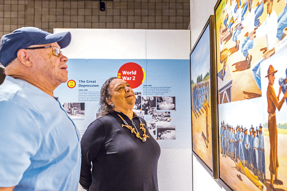 A man and woman view an exhibit within “African Americans Fighting for a Double Victory” at the National Afro-American Museum & Cultural Center in Wilberforce (photo by Matthew Allen)