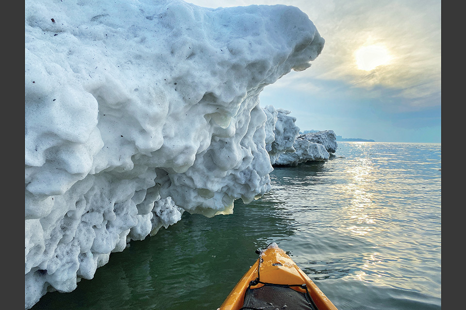 Kayaker on Lake Erie passes buy large chunk of ice (photo by Daryl Mummey)