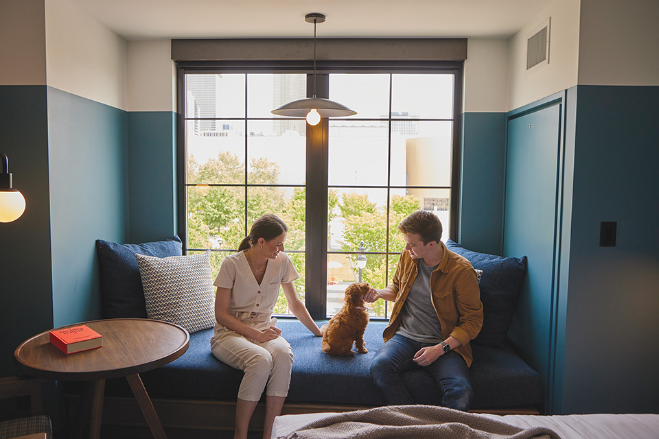 Couple with puppy at room in The Junto hotel in Columbus (photo courtesy of The Junto)