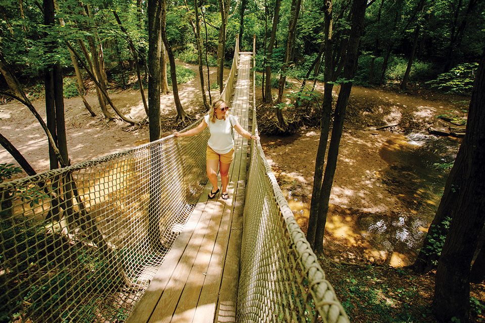 Woman on rope bridge at Scioto Grove Metro Park in Grove City (photo by Rachael Jirousek)