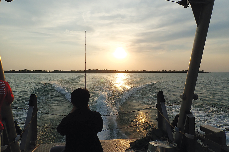 Man fishing from back of boat on Lake Erie (photo courtesy of Ohio Sea Grant)