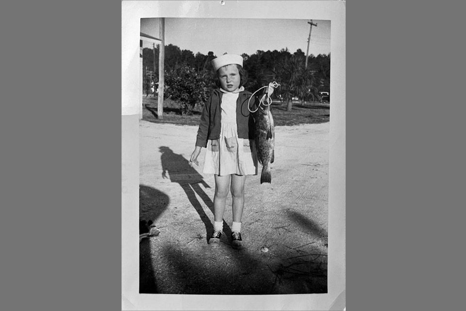 Peg VanVleet as a child with a fish at Lake Erie (photo courtesy of Peg VanVleet)