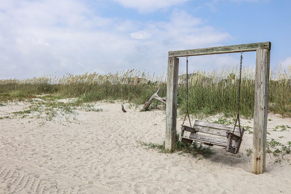 Wooden swing on beach